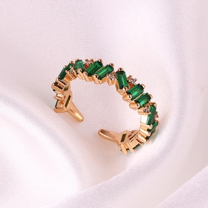 Adjustable gold open ring with rectangular emerald stones and small white crystals