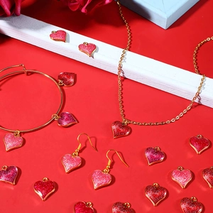 Golden heart jewelry set with pink glitter pendants including necklace and earrings