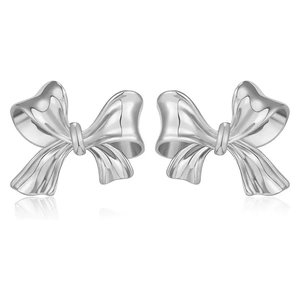 Close-up of polished silver bow stud earrings with realistic ribbon texture detail