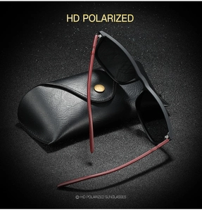 Detail of HD polarized sunglasses with square frame and leather case on dark background