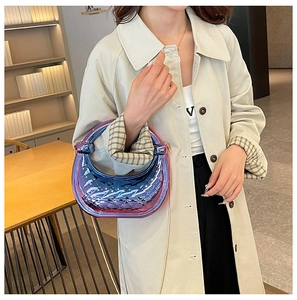Detail of luxury crescent acrylic handbag featuring blue purple gradient and diamond texture