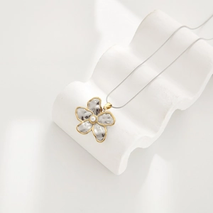 Minimalist flower pendant necklace with silver hammered metal and white pearl on snake chain