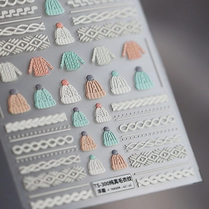 3D embossed nail stickers featuring winter sweater patterns and knit textures in pastel tones