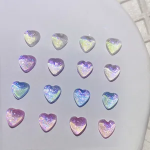 Polarized heart-shaped nail gems with iridescent shimmer in multiple colors on a stand