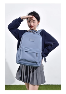 Detail of light blue nylon student backpack featuring large capacity and stylish design