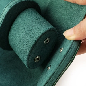 Deep green suede watch storage box with soft cushion and secure snap button closure
