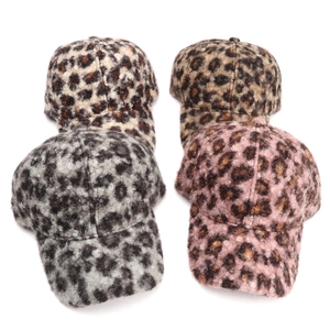 Detail view of leopard print baseball caps in plush fleece, showing four color options