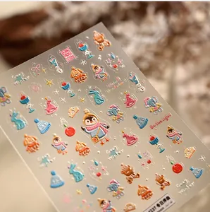 Detailed macro view of 3D embossed winter animal nail stickers with cute festive motifs