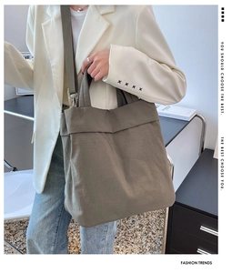 Army green large nylon tote bag carried by a model in a stylish cream blazer outfit