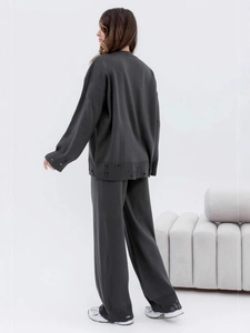 Distressed dark grey two-piece knit set featuring an oversized sweater and wide-leg pants