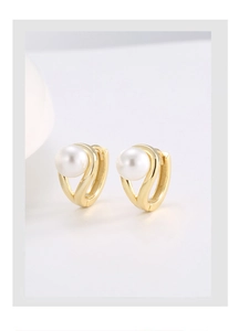 Close-up of elegant gold S925 silver earrings with lustrous round white shell pearls