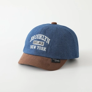 Detail of Brooklyn embroidery on blue denim and brown suede baseball cap for toddlers