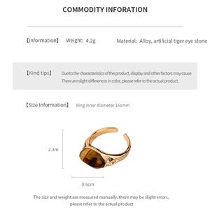 Macro detail of vintage gold-plated ring with artificial tiger eye stone measurements
