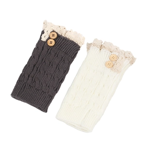 Detail of cable knit leg warmers with delicate lace trim and vintage wooden buttons