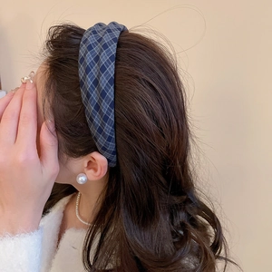 Close-up of blue checkered fabric headband on model with high crown stylish design