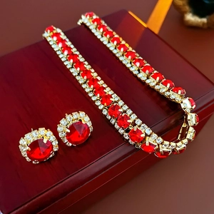 Detailed close-up of a luxury red square jewelry set with necklace and earrings
