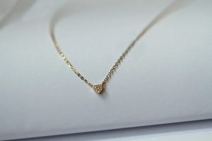 Macro shot of 14k gold-plated 925 silver heart necklace with pavé-set cubic zirconia