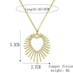 Detail view of gold heart pendant with dimensions 3.3x2.7cm and copper zircon materials