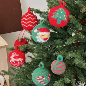 Knitted Christmas tree ornaments set with reindeer and Santa patterns on tree branches