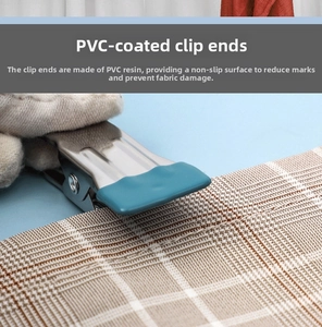 Detail of stainless steel clip with turquoise PVC coating holding checkered fabric firmly