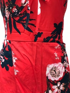 Detail of red floral dress with drawstring neckline and high waist side slit