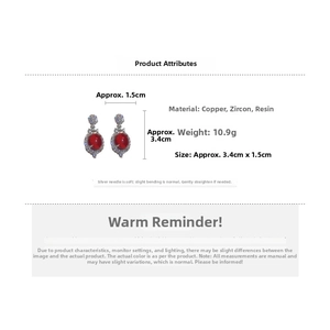Detail view of red crystal oval flower earrings with dimensions 3.4cm by 1.5cm