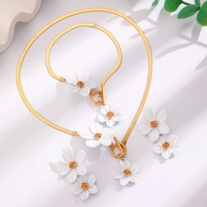 Elegant gold snake chain jewelry set with white floral pendants and earrings