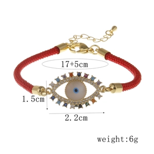 Detail of colorful zircon evil eye charm on red braided rope bracelet with dimensions