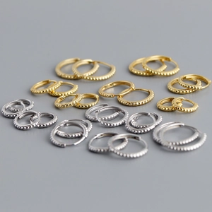 Detailed view of S925 sterling silver beaded hoop earrings in gold and silver finishes