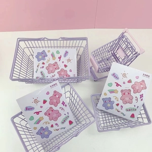 Close-up of four lavender purple wire metal mini baskets with cute bear lining stickers