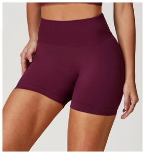 Detail of seamless high-waist yoga shorts in deep purple with ribbed tummy control belt