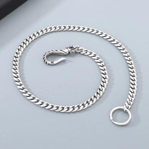 Macro view of silver dragon-hook Cuban link trouser chain with industrial metal texture