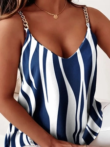 Detail of V-neck printed camisole with golden metal chain straps and zebra pattern