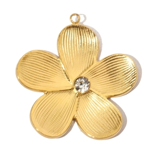Detail of a vintage golden flower pendant with diamond setting and textured petals