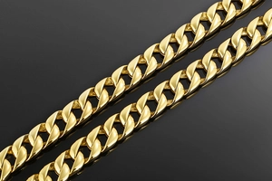 Detail of 15mm gold Cuban link chain showing dense links and polished metal texture