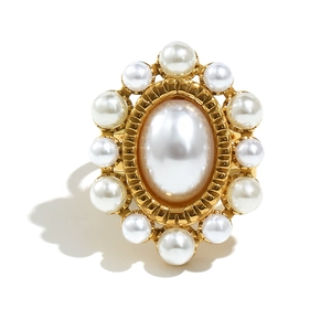 Detail showing vintage gold olive ring with large white oval pearl and floral design