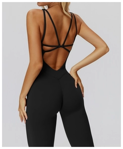 Macro detail of cross-back straps on black flare jumpsuit yoga bodysuit for women
