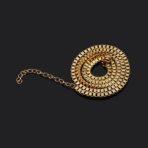Detail of 18k gold plated box chain link texture and extension clasp on black background