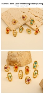 Close-up of gold-plated stainless steel ring featuring colorful dried flower inlay