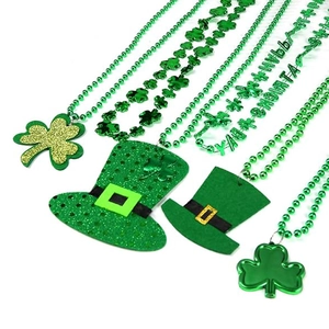 Green St. Patrick's Day necklace set featuring shamrock pendants and festive hat charms
