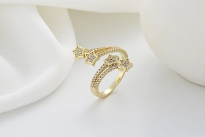 Detailed macro shot of golden twisted star ring with sparkling cubic zirconia inlay