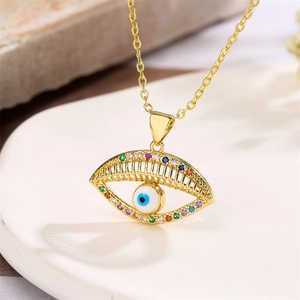 Macro view of gold evil eye necklace pendant with colorful zircon stones and nazar bead