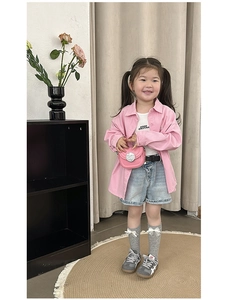 Pink mini crossbody bag styled with a girl's casual outfit in a professional studio setting
