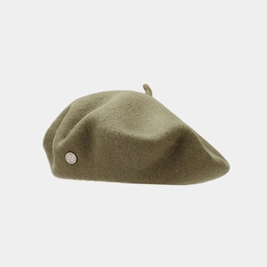 Detail of olive green wool beret with small silver 1988 metal emblem on the side