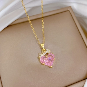 Luxurious gold titanium necklace with pink heart gemstone and sparkling crown pendant