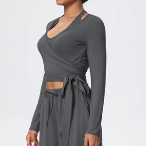 Detail of dark gray wrap V-neck yoga top with waist ties and brushed athletic fabric
