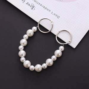 Detail of beaded pearl chain for clog shoes and bags featuring silver spring rings