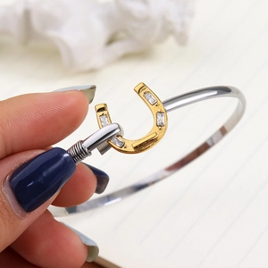 Elegant 18K gold plated horseshoe bangle with sparkling cubic zirconia in two-tone finish