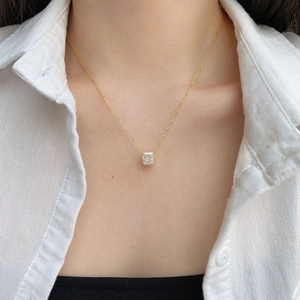 Detail of 18K gold S925 silver necklace with square ice cut zircon on a white shirt