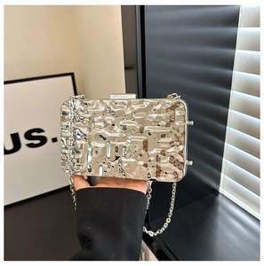 Detail of silver metallic evening clutch showing liquid metal hammer texture and snap closure